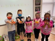 1st graders holding pumpkins